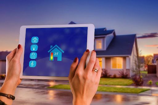 Using a tablet to control smart home features in a modern house.