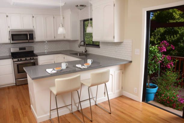 White kitchen with modern decor and sleek glass splashbacks in the background. 