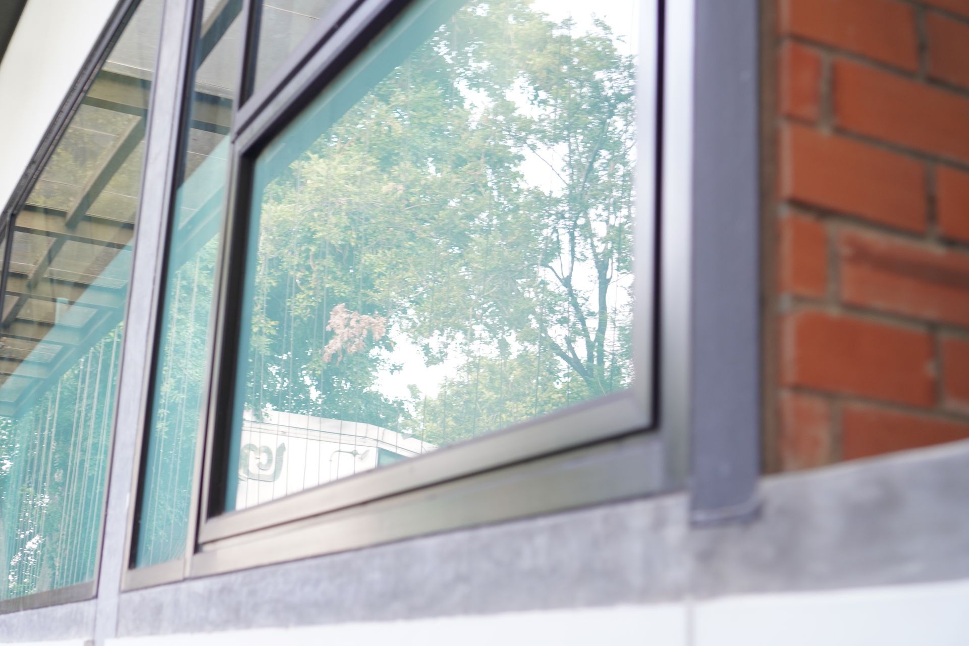 Modern building exterior with reflective glass and sleek commercial aluminium windows frame.