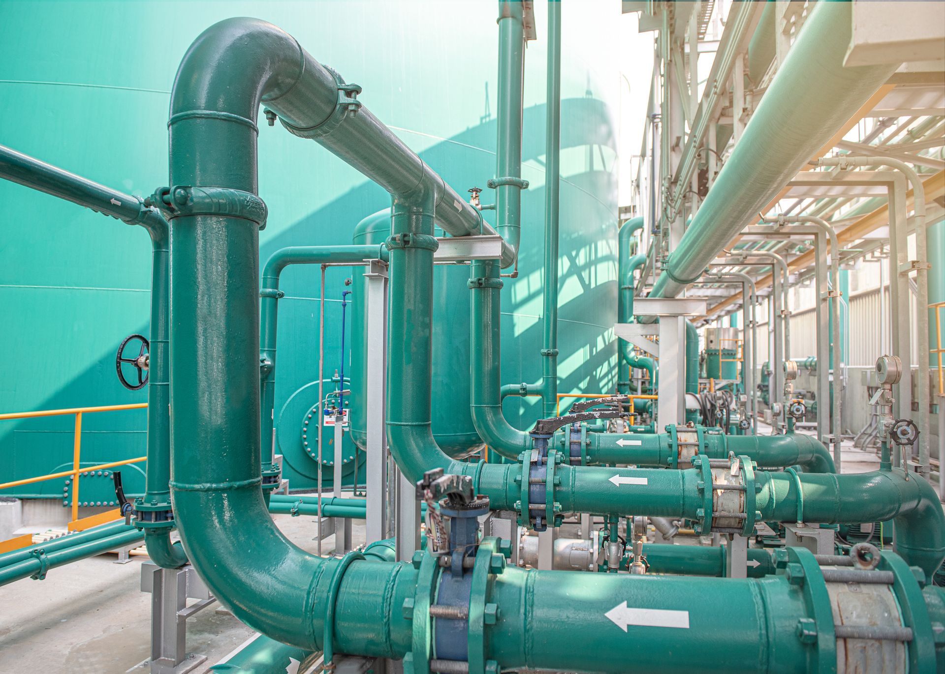 A row of green pipes with an arrow pointing to the right – Grand Rapids, MI - Paul J. Sommerdyke Plumbing