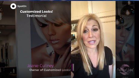 A woman is standing in front of a picture of a woman.