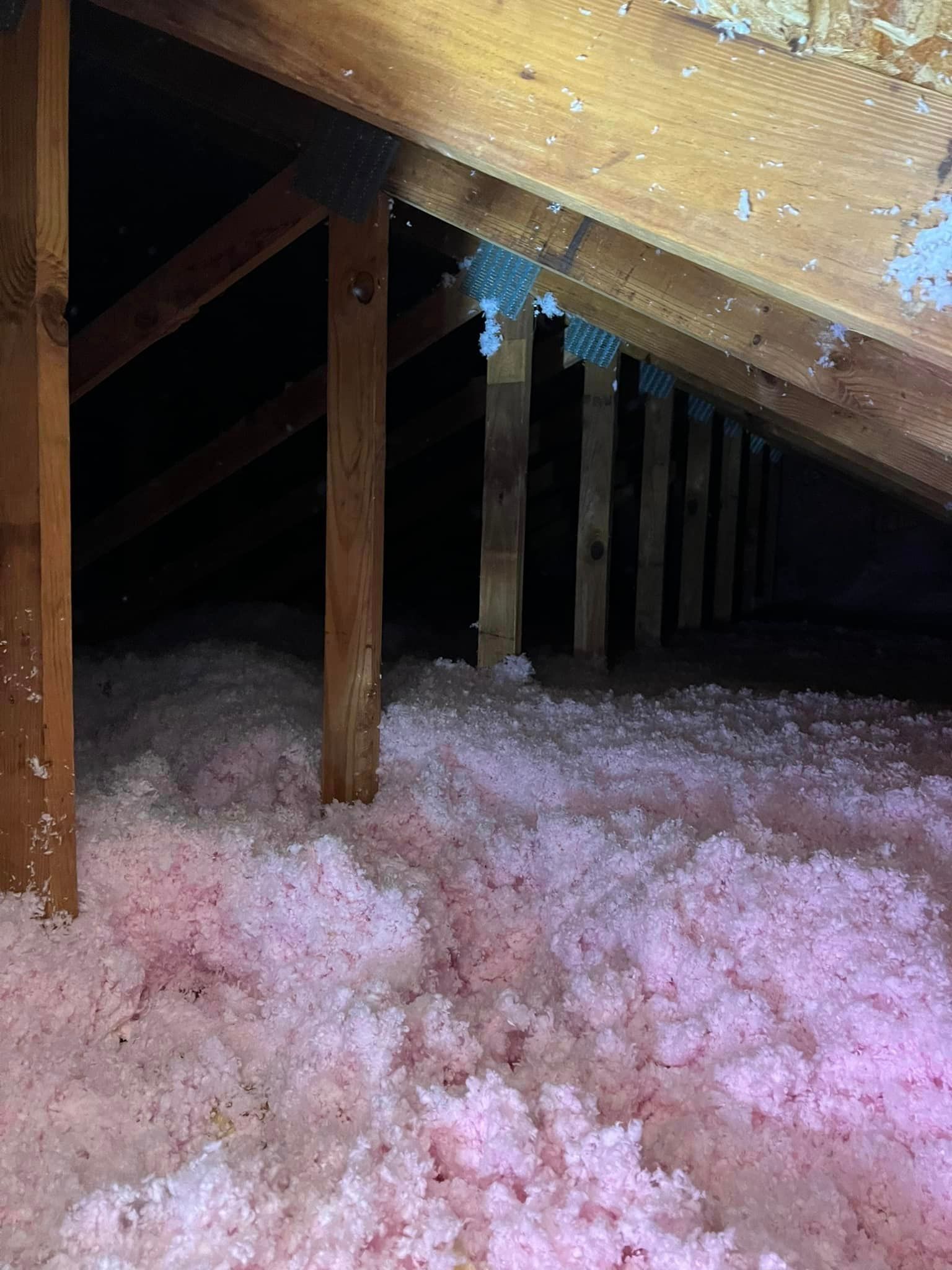 There is a lot of pink insulation in the attic.