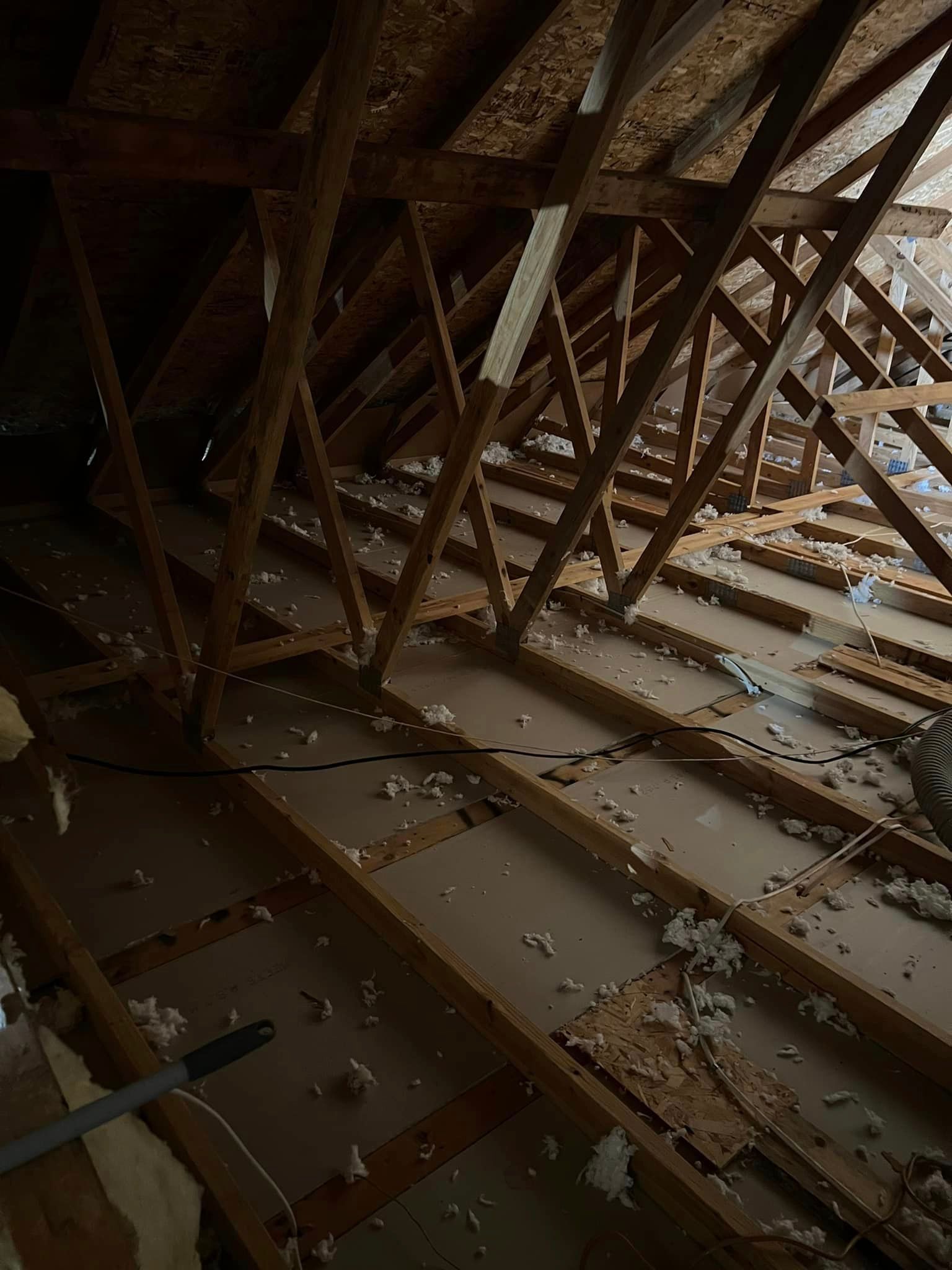 A person is working on the attic of a house.