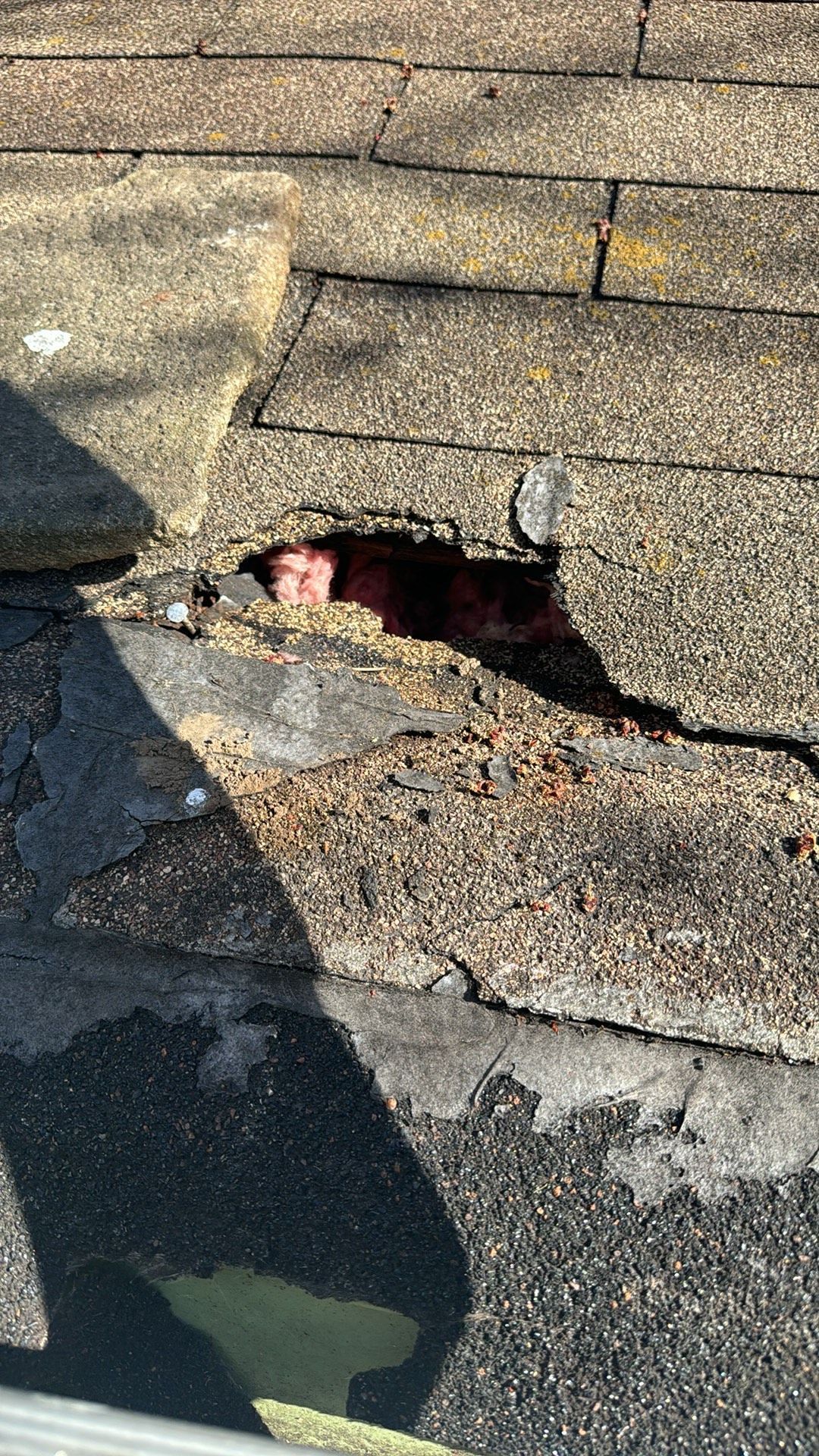 There is a hole in the roof of a building.