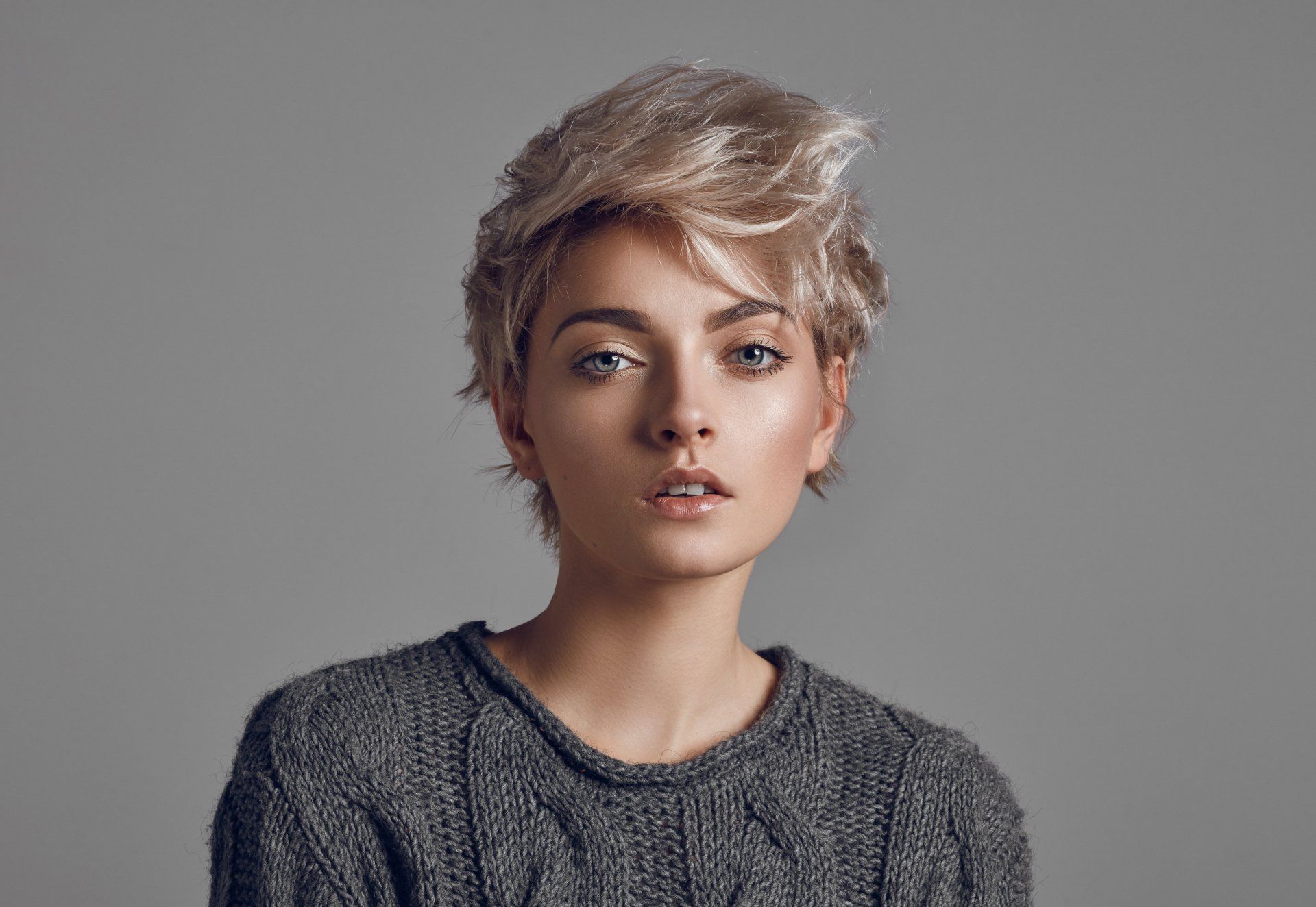 Fashion portrait of young woman with short blond hair