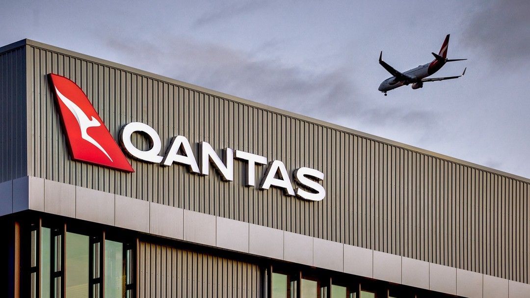 Qantas Building With Red Logo, Airplane Flying In Sky — Zeal Interiors in South Grafton, NSW