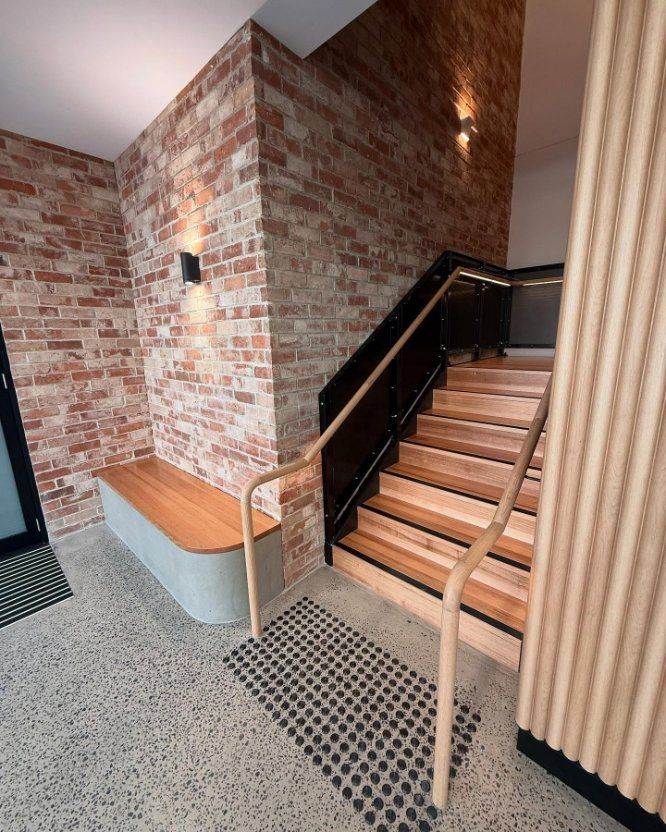 Brick Wall Entryway With Wooden Stairs And A Bench — Zeal Interiors in South Grafton, NSW