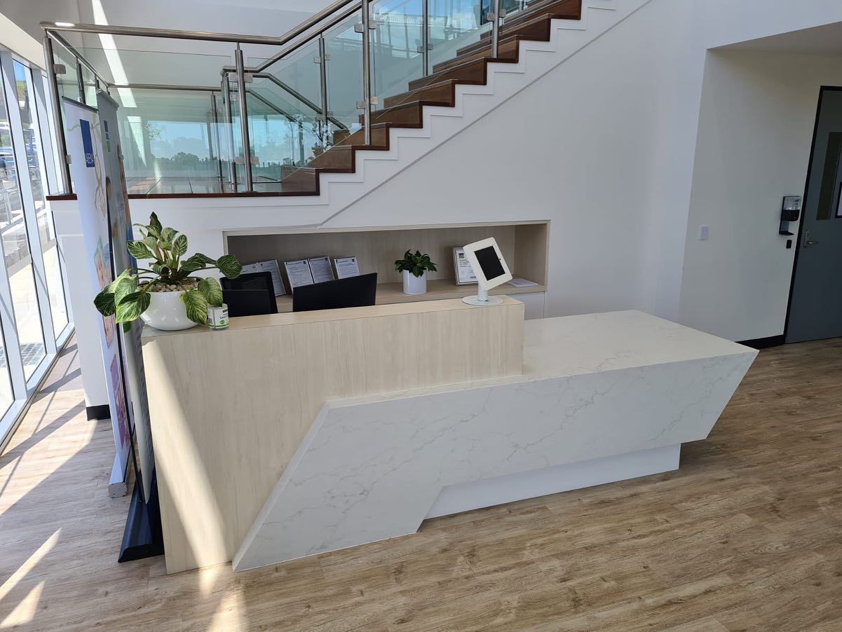 Reception Area With Cae Logo, Dark Wood Accents — Zeal Interiors in South Grafton, NSW