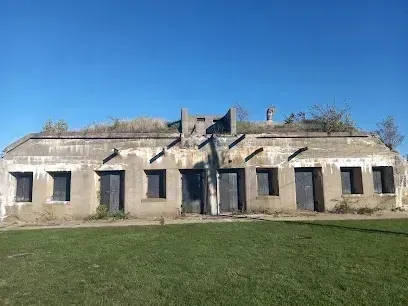 Chimney sweep Portland Maine - Low concrete bunker with multiple doorways and windows under a clear blue sky.