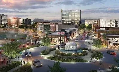 Chimney sweep portland maine - A modern mixed-use development with shops, offices, and a water feature at dusk.