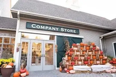 Chimney sweep portland maine-A company store entrance is decorated with a large display of pumpkins and hay bales for autumn.
