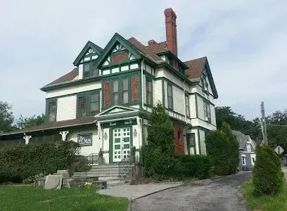Chimney sweep portland maine - Large white Victorian house with green trim and a prominent brick chimney.