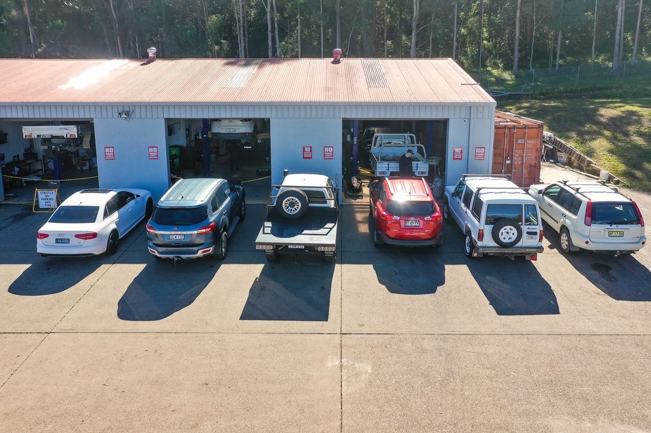 A Red and White Race Car is Parked in a Garage — AA Automotive Repairs in Forster, NSW
