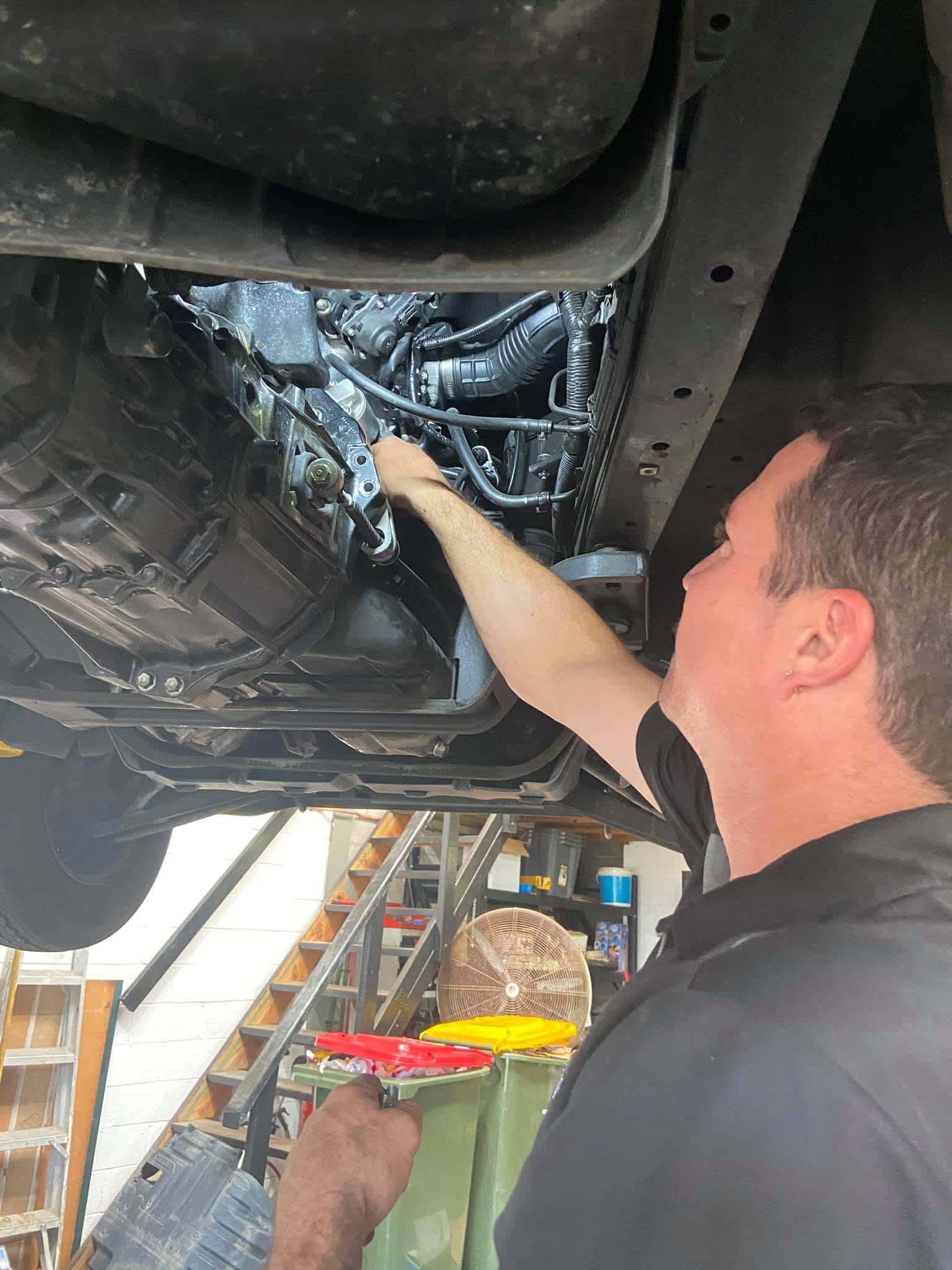 A Man is Working on the Underside of a Car — AA Automotive Repairs in Forster, NSW