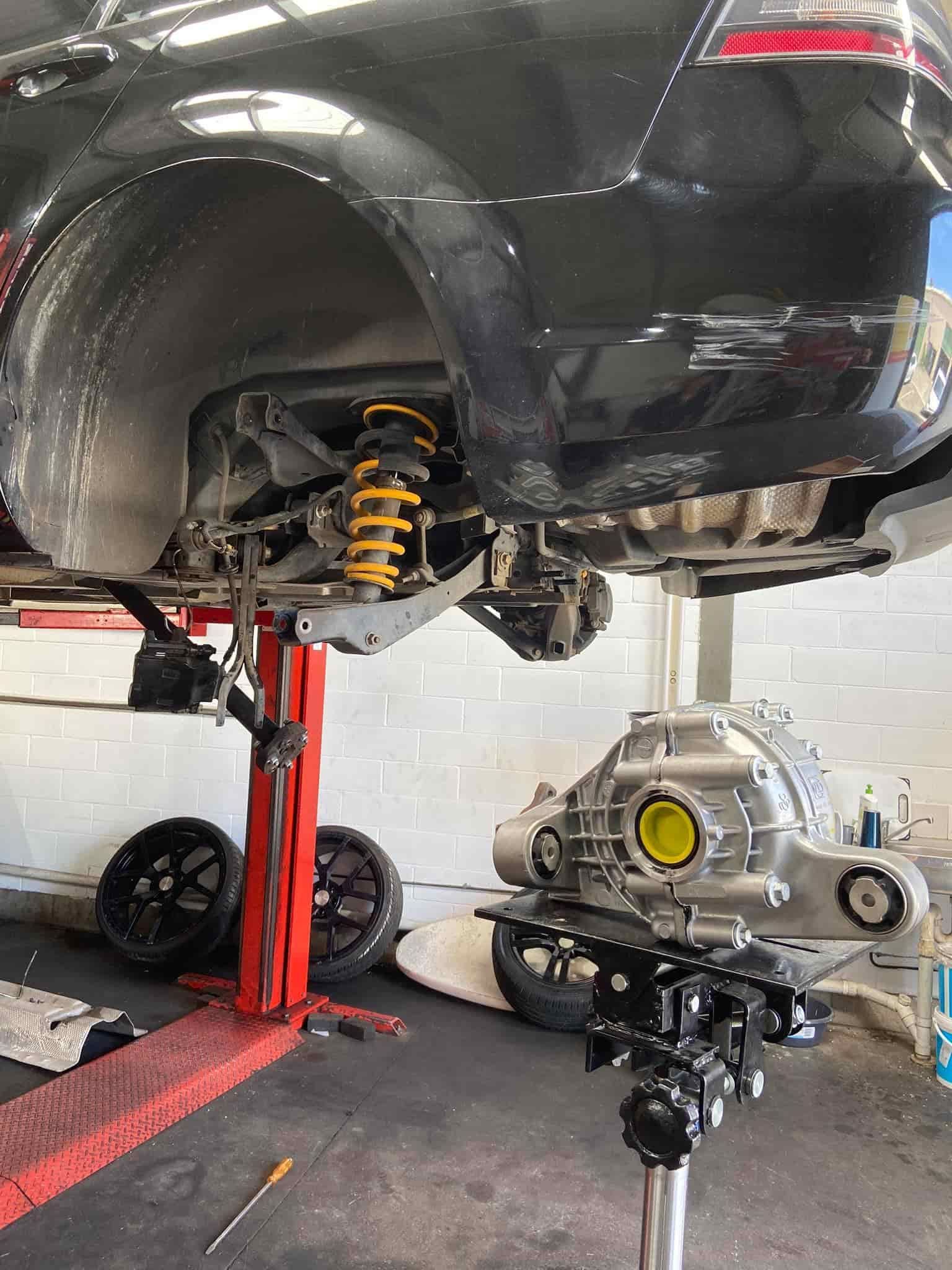 A Car is Sitting on a Lift in a Garage — AA Automotive Repairs in Forster, NSW