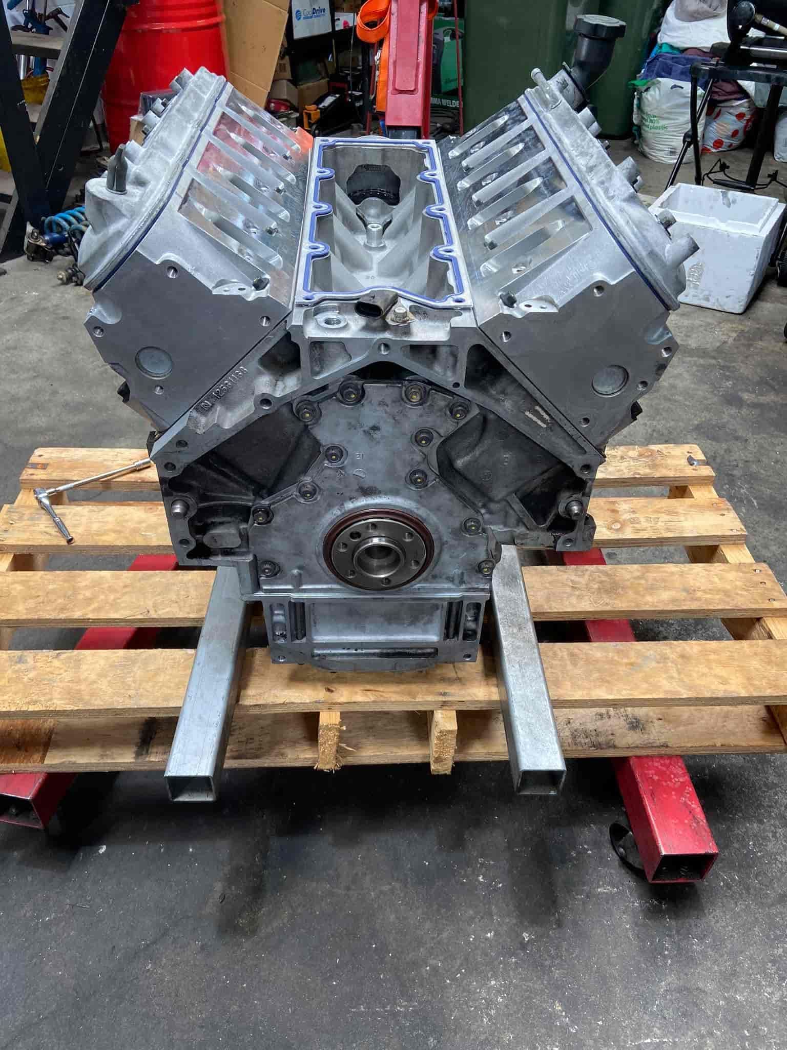 A large Engine is Sitting on Top of a Wooden Pallet — AA Automotive Repairs in Forster, NSW