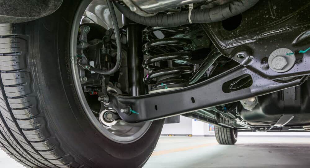 A Close Up of the Underside of a Car With a Tyre and Shock Absorber — AA Automotive Repairs in Forster, NSW