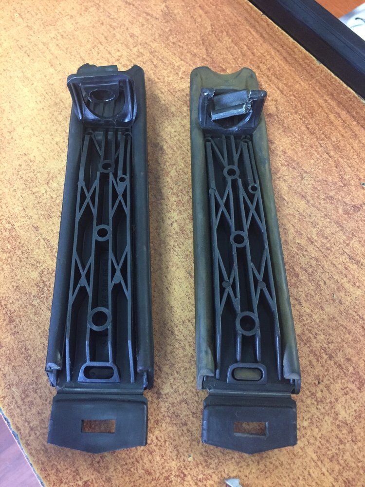 Two Pieces of Plastic Are Sitting On A Wooden Table | Alpine Auto House Inc.