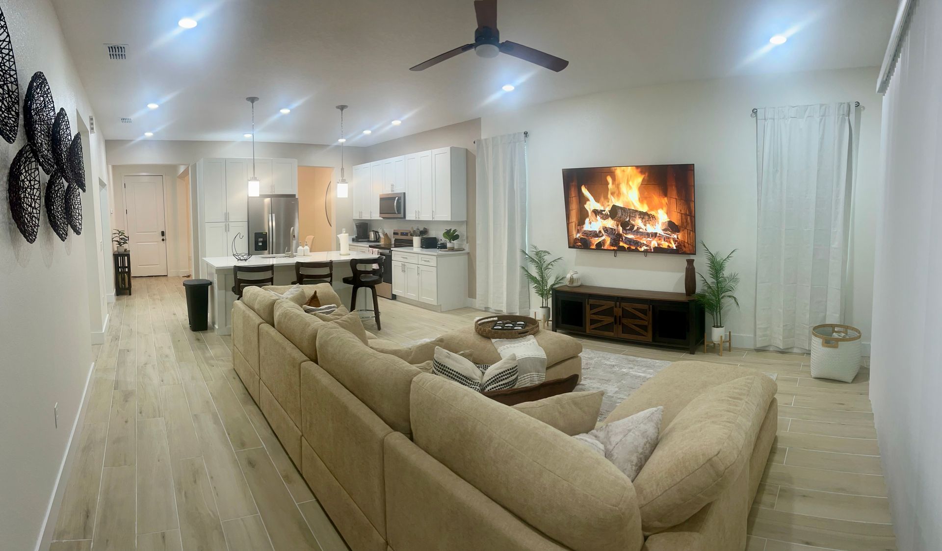 Hand holding house keys in front of a staircase.