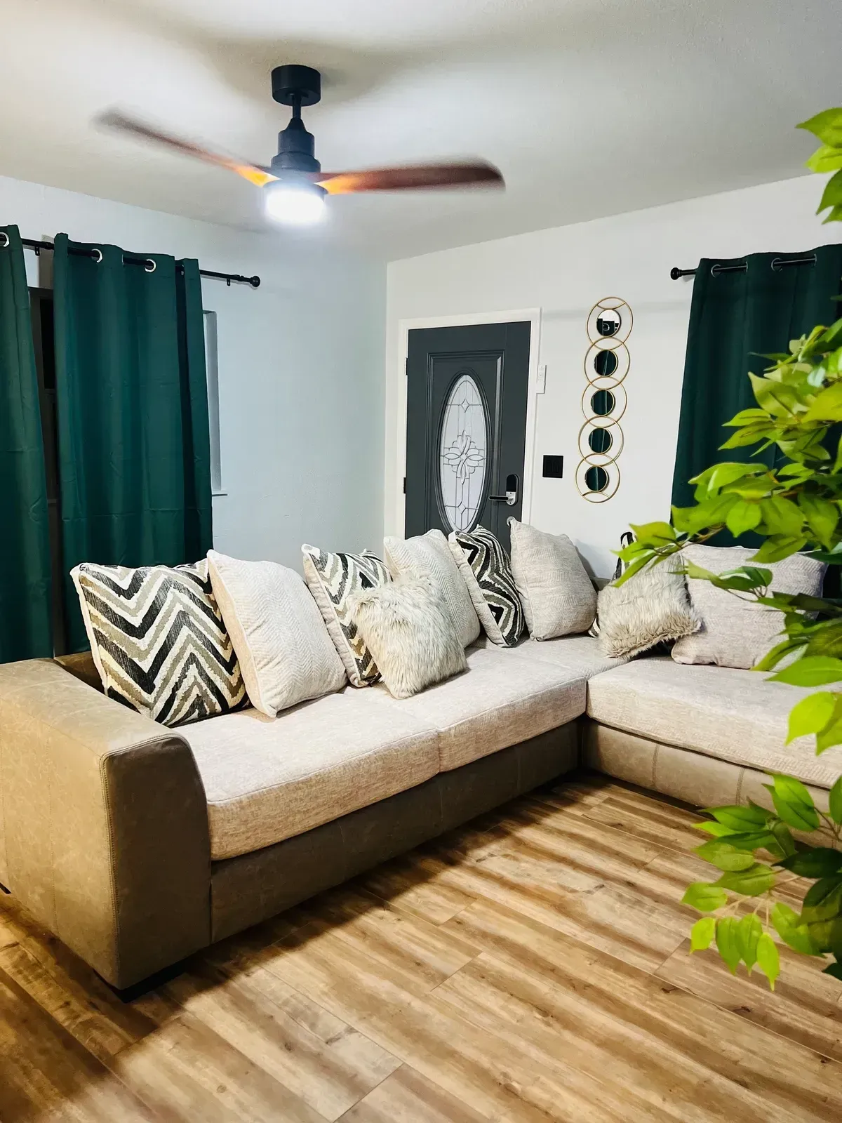 Hand holding house keys in front of a staircase.