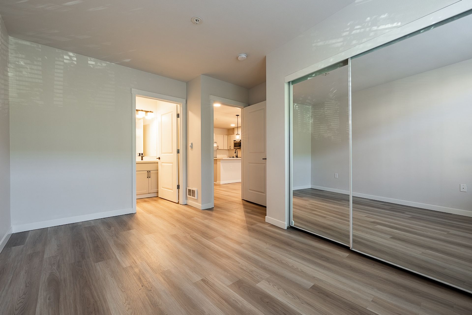 bedroom with mirrored closet doors