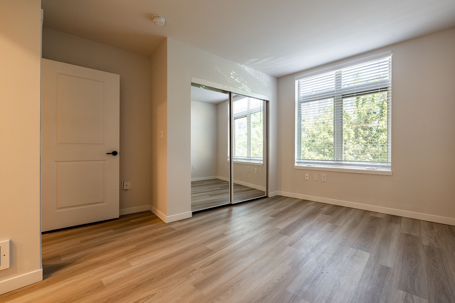 bedroom with mirrored sliding doors
