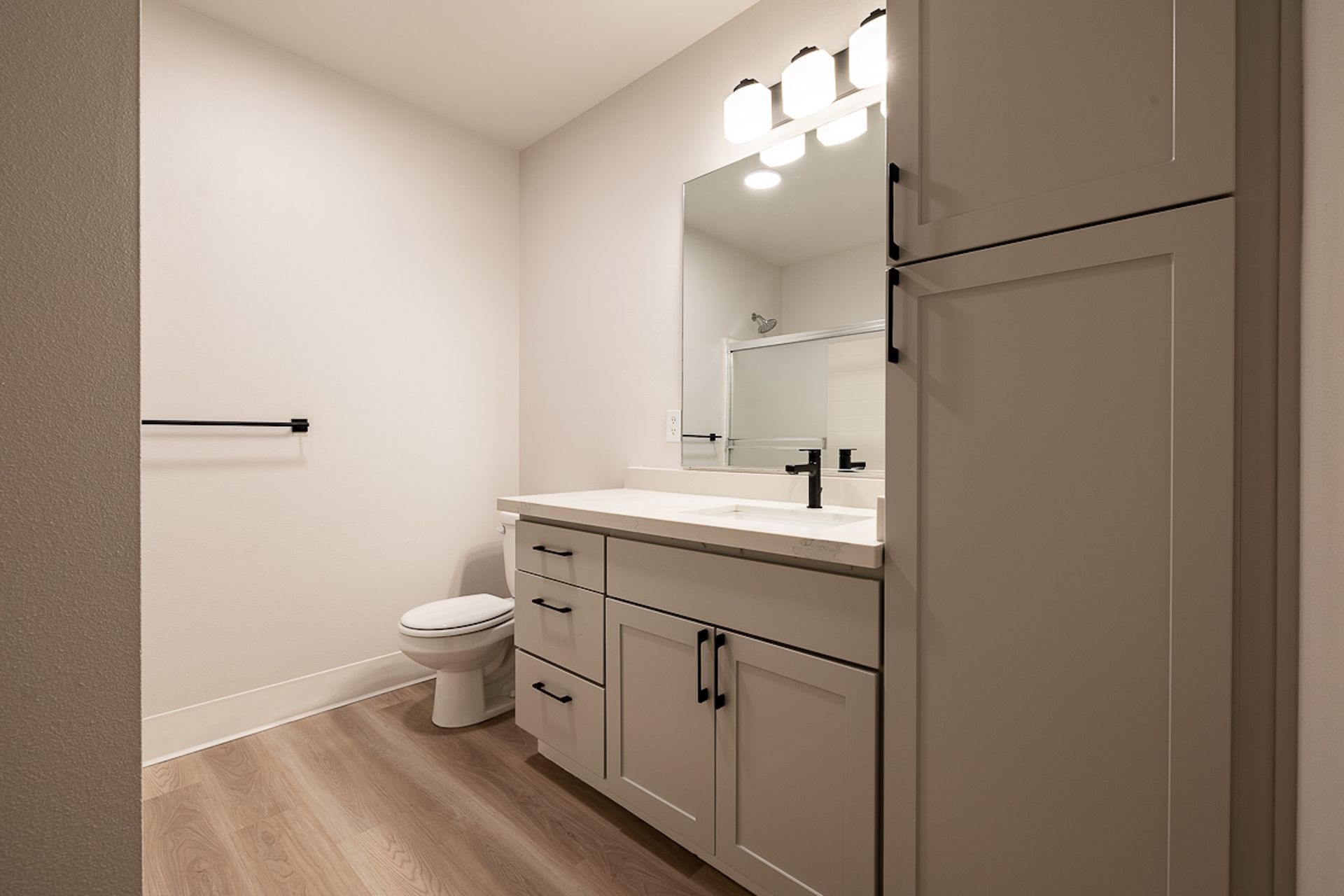 bathroom with gray cabinets