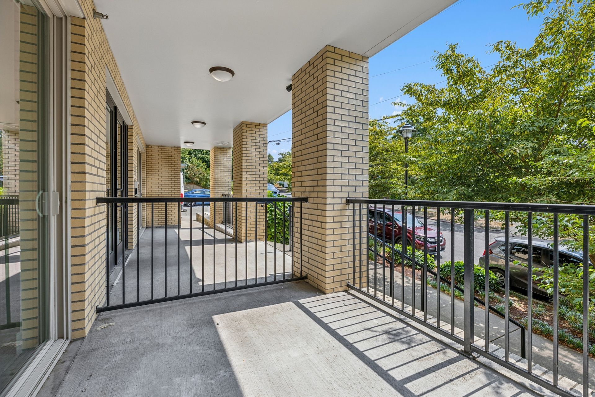 covered balcony with black rails 