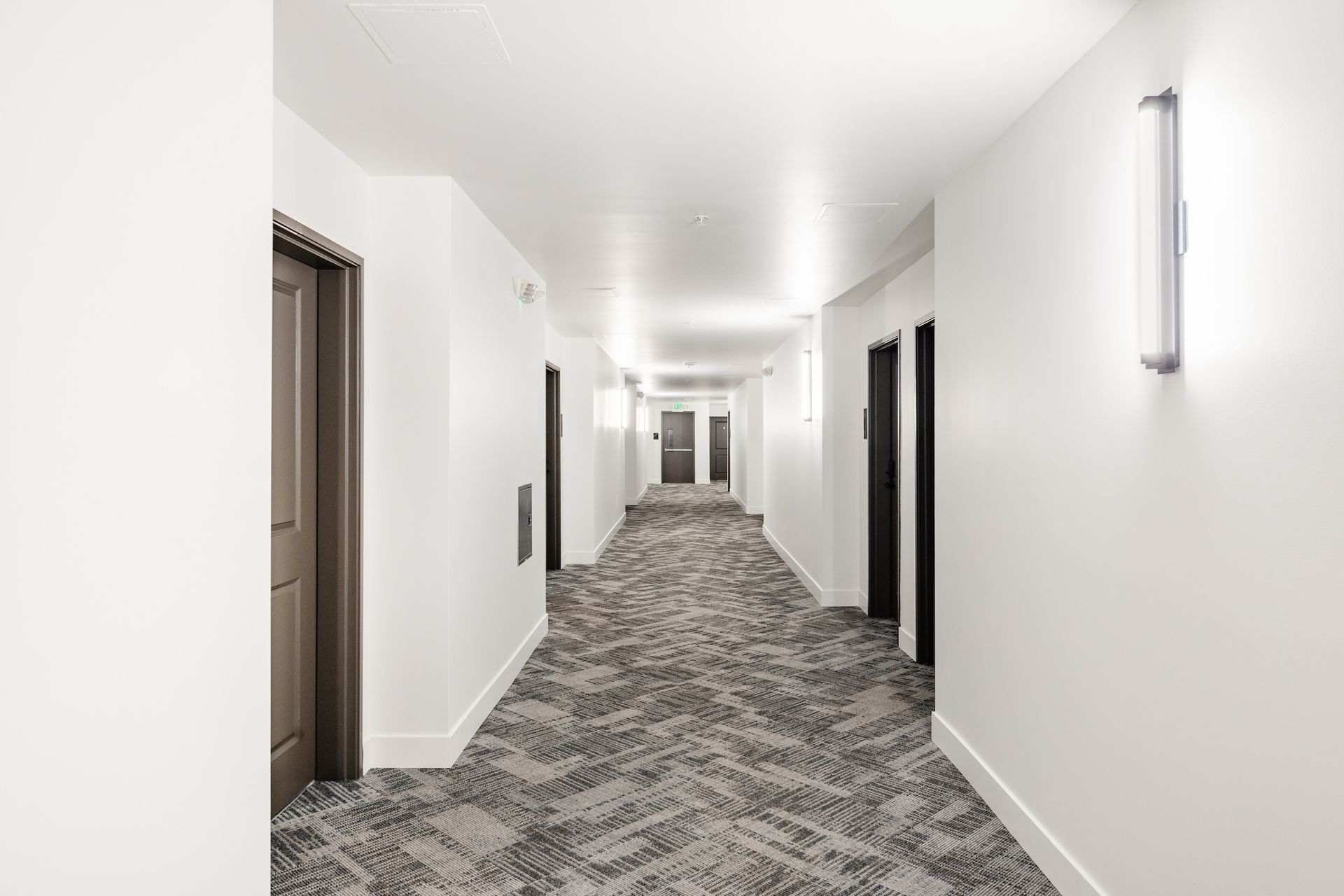 hallway with gray carpets