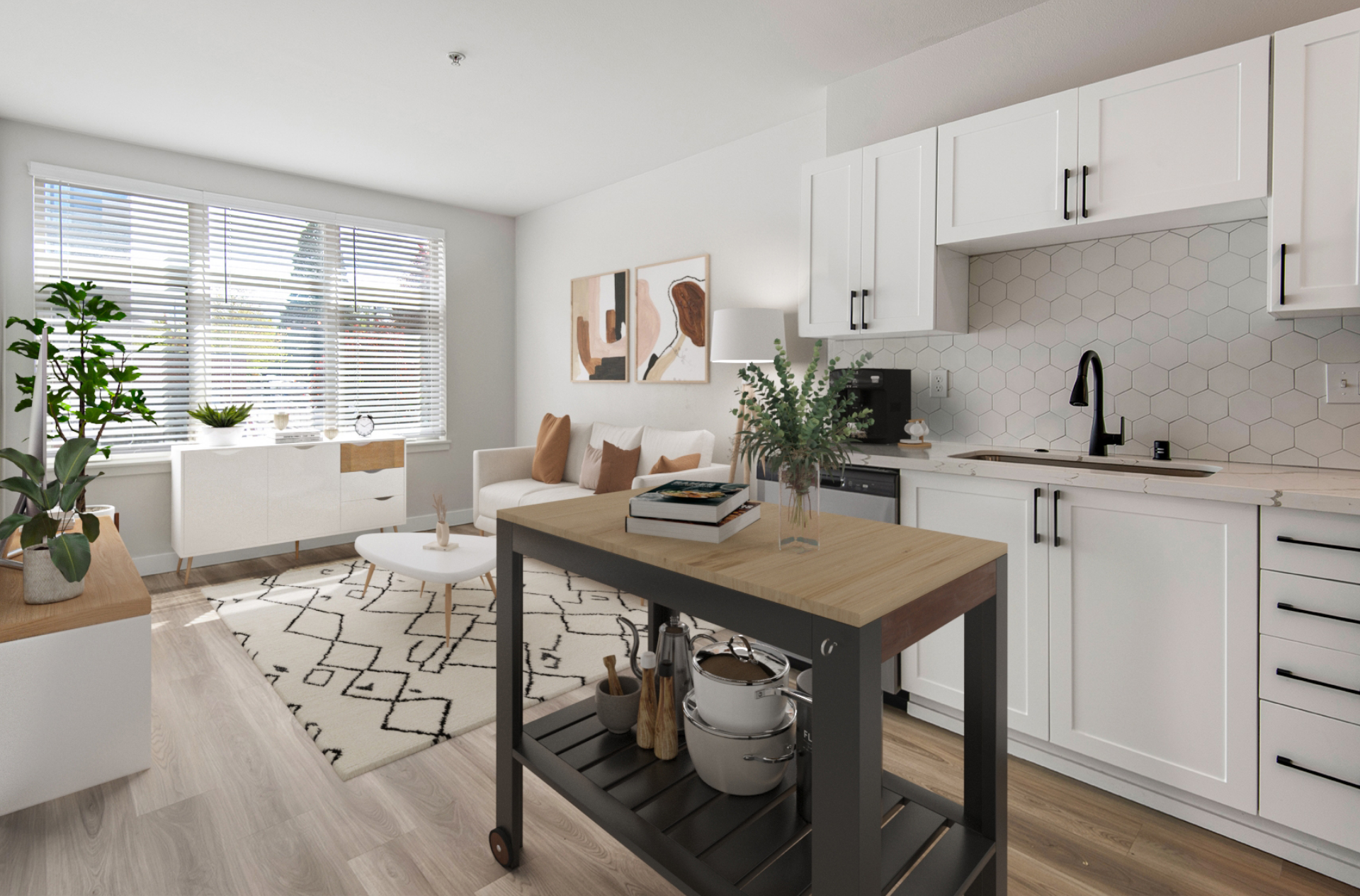 A kitchen with white cabinets and a small island in the middle