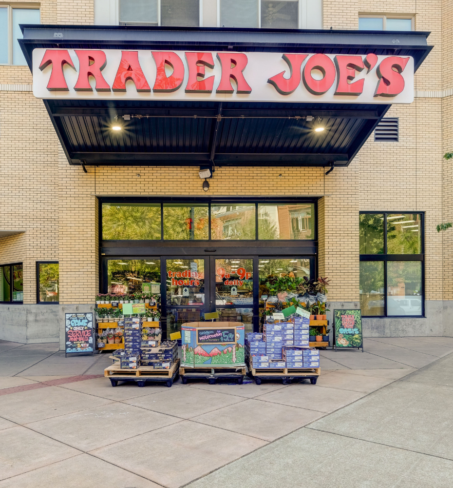 A trader joe 's store with a lot of boxes in front of it