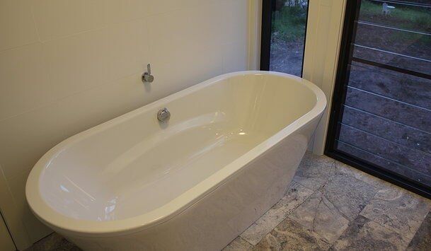 White Bath Tub — Builders  in Fernhill, NSW