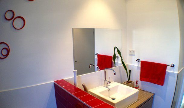 Bathroom With Red Accents — Builders  in Fernhill, NSW