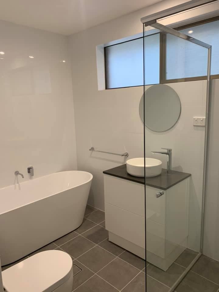 A Bathroom With a Bathtub, Sink, Toilet and Shower — Craig Allman Construction Pty Ltd In Fernhill, NSW