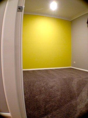 Bedroom with Yellow Feature Wall — Builders  in Fernhill, NSW