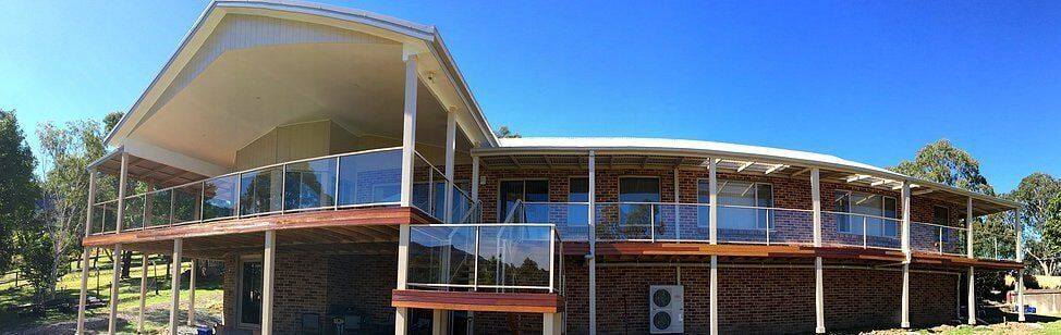 House with Glass Balcony — Builders  in Fernhill, NSW