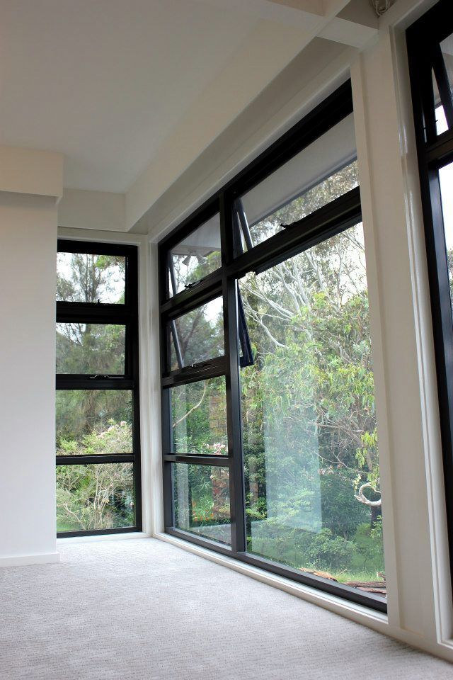 An Empty Room With a Lot of Windows and Trees in the Background — Craig Allman Construction Pty Ltd In Fernhill, NSW