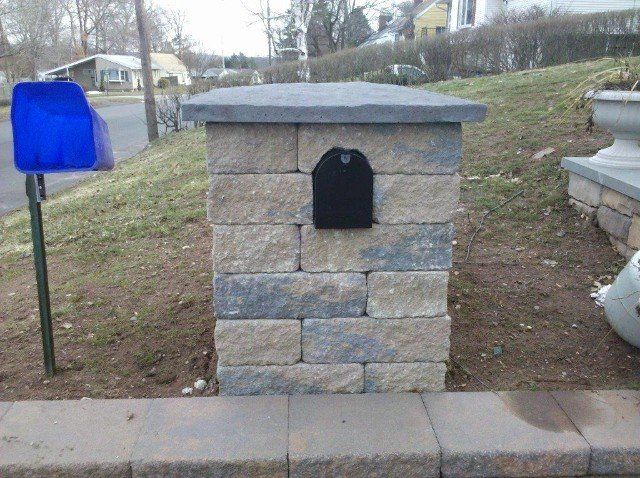 Mailbox surrounding with brick protection - front yard landscaping services - Stellato Bros. Inc. in Feeding Hills, MA