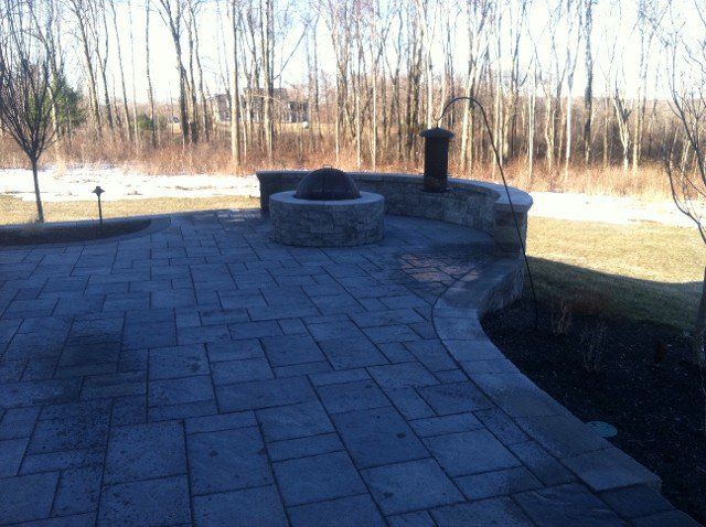 Stone and Brick patio with fireplace - front yard landscaping services - Stellato Bros. Inc. in Feeding Hills, MA
