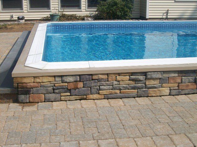 Back yard brick walkway with stone retainer wall for the pool - back yard landscaping services - Stellato Bros. Inc. in Feeding Hills, MA