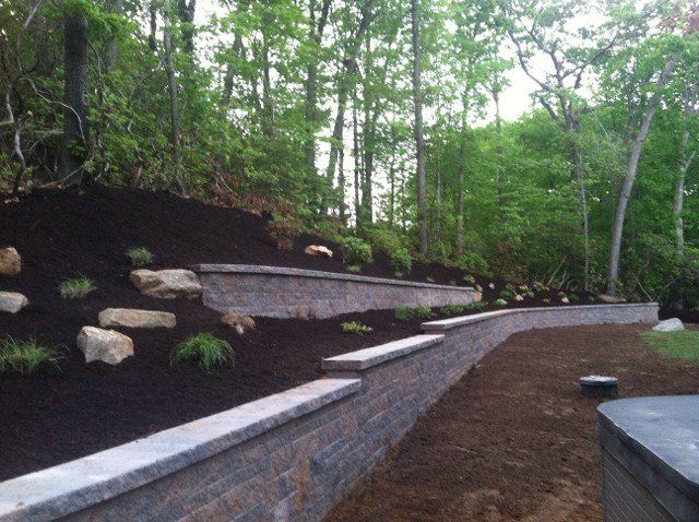 Retainer wall design with bricks and stone - brick pavers, walkways and patios landscaping services - Stellato Bros. Inc. in Feeding Hills, MA