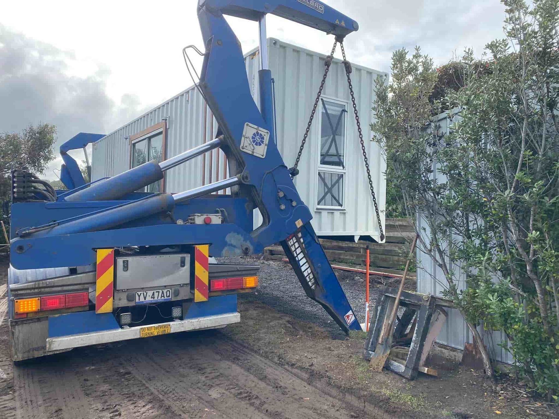 Blue Dump Truck Carrying A White Container — GTH Living In Geelong, VIC
