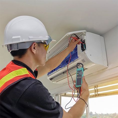 A Technician Repairing an AC — Grants Pass, OR — Jahnke Heating & Air