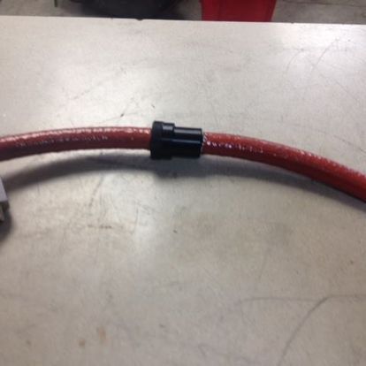 A red hose is sitting on a white table