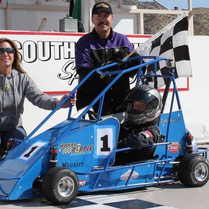 A blue go kart with the number 1 on it