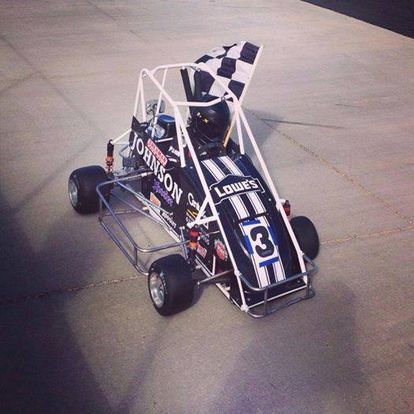 A small race car with a checkered flag on top of it