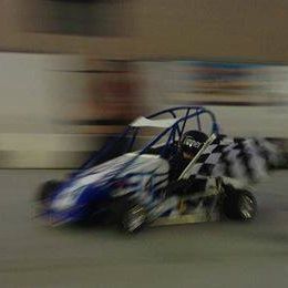 A person is driving a race car on a track.