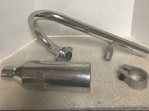 A close up of a motorcycle exhaust pipe on a table.