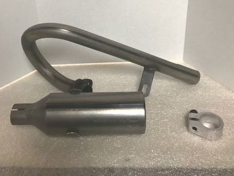 A stainless steel exhaust pipe is sitting on a white surface.