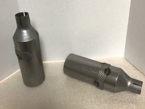 Two metal bottles are sitting next to each other on a table.